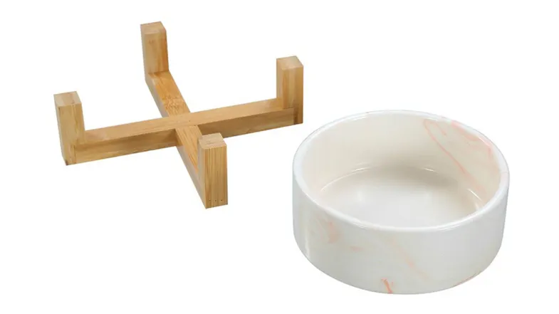 A top-down view of the ceramic pet bowl, marble/wood base in pink colour A top-down view of the ceramic pet bowl, marble/wood base in pink colour