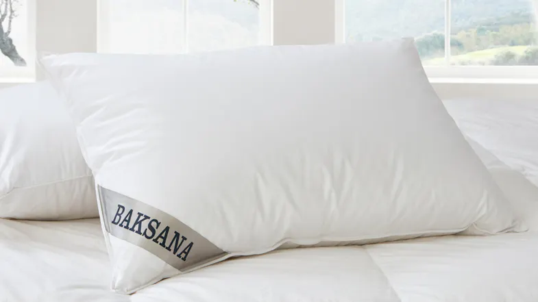 Baksana Hungarian Goose Down & Feather Firm Pillow displayed on a bed with white linens Baksana Hungarian Goose Down & Feather Firm Pillow displayed on a bed with white linens