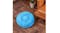 A blue Hod Snuggly Pooch Dog Bed is placed on a wooden floor beside a brown leather sofa and a small potted plant A blue Hod Snuggly Pooch Dog Bed is placed on a wooden floor beside a brown leather sofa and a small potted plant