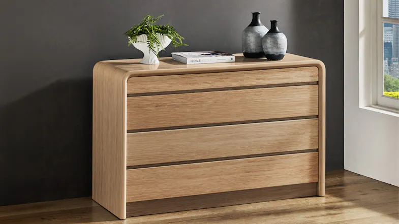 Arc 4 Drawer Lowboy in light oak with rounded edges and decorative vases on top Arc 4 Drawer Lowboy in light oak with rounded edges and decorative vases on top