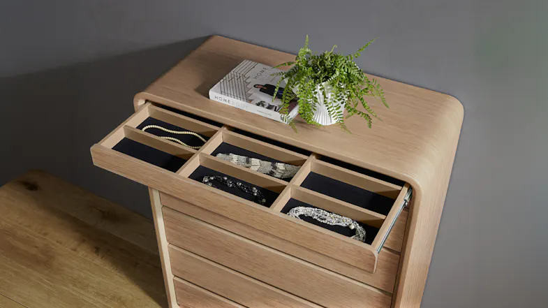 Top drawer of the Arc Tallboy open, revealing a black felt-lined jewelry organiser Top drawer of the Arc Tallboy open, revealing a black felt-lined jewelry organiser