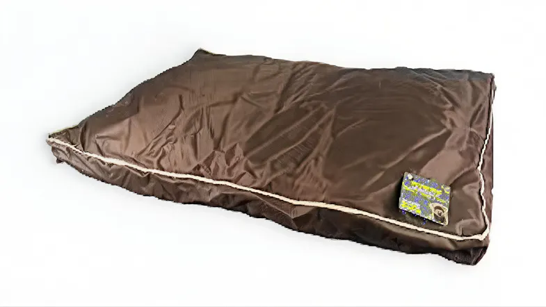 Brown rectangular waterproof cushioned pet bed with beige piping, slightly wrinkled fabric, and a small tag Brown rectangular waterproof cushioned pet bed with beige piping, slightly wrinkled fabric, and a small tag