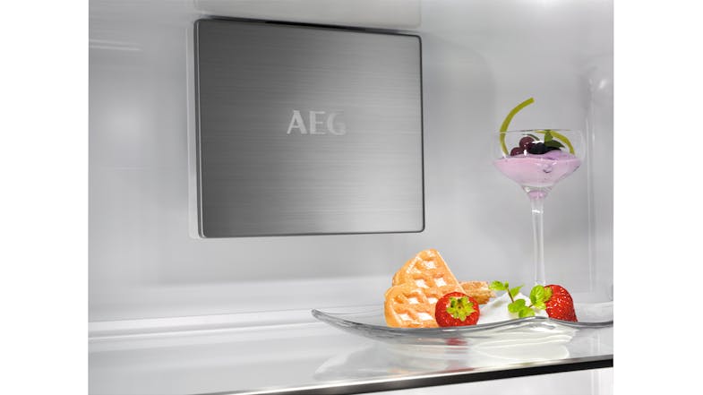 A metal cooling plate with an engraved logo above a glass shelf A metal cooling plate with an engraved logo above a glass shelf
