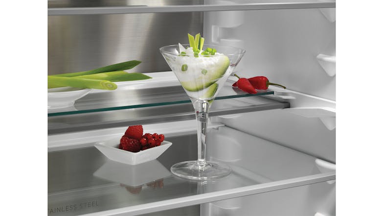 Close-up view of clear glass shelves holding desserts and fresh berries Close-up view of clear glass shelves holding desserts and fresh berries