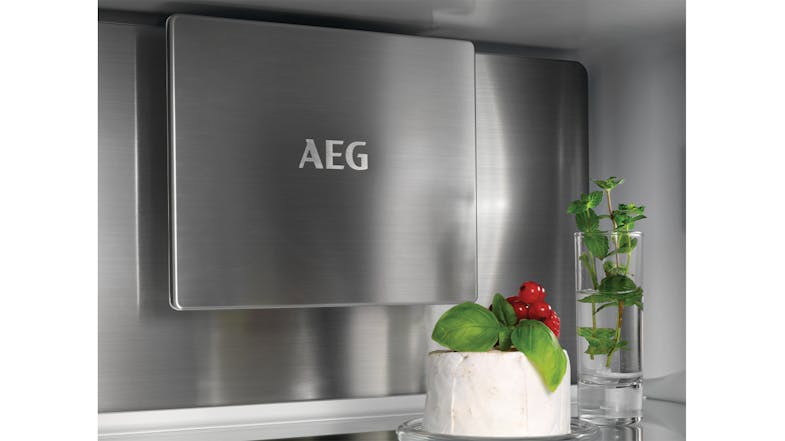 A metal cooling plate with an engraved logo above a glass shelf A metal cooling plate with an engraved logo above a glass shelf