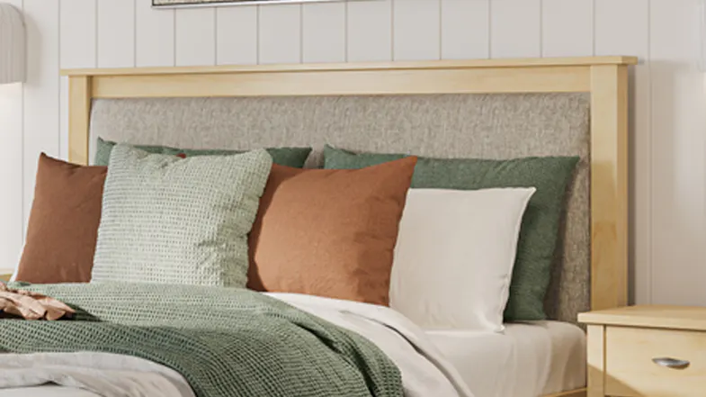 Close-up view of a headboard with a grey textured fabric insert Close-up view of a headboard with a grey textured fabric insert