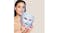 Woman holding a sleek mask that glows with soft light Woman holding a sleek mask that glows with soft light