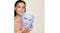 Woman holding a sleek mask that glows with soft light Woman holding a sleek mask that glows with soft light