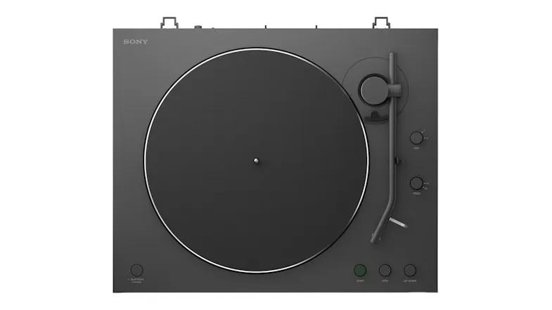 Top-down view of the automatic turntable showing the tonearm and circular platter Top-down view of the automatic turntable showing the tonearm and circular platter