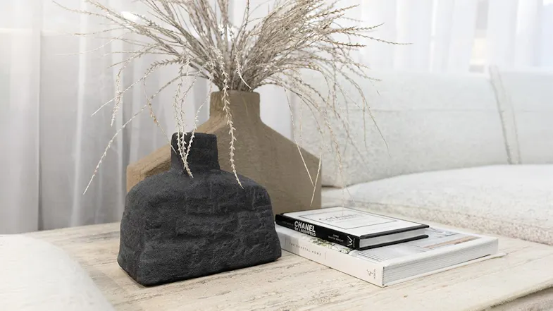 Modern stone vases beside books Modern stone vases beside books
