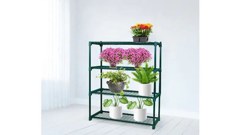 A four-tier green metal plant stand displayed indoors, holding colourful flowers and leafy plants, showing strong grid shelves anda stable frame A four-tier green metal plant stand displayed indoors, holding colourful flowers and leafy plants, showing strong grid shelves anda stable frame