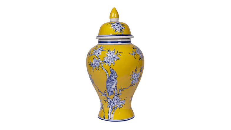 A yellow lidded ceramic jar decorated with blue floral branches and a bird, featuring a rounded body and narrow base A yellow lidded ceramic jar decorated with blue floral branches and a bird, featuring a rounded body and narrow base