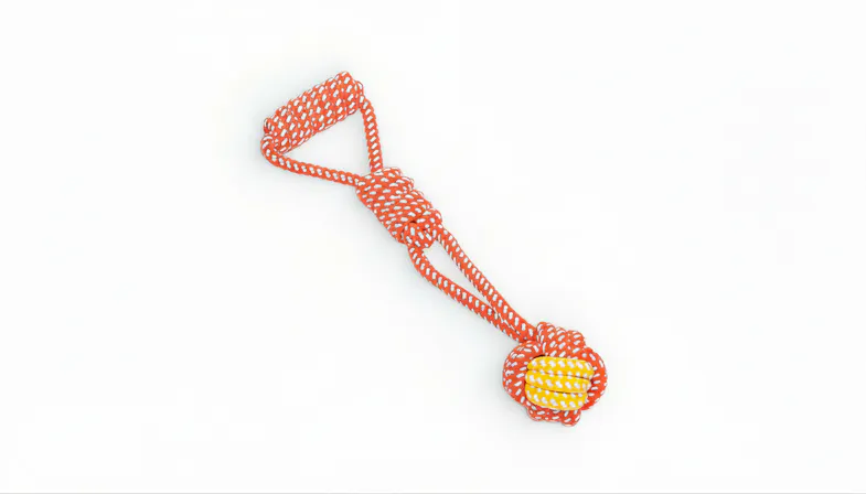 A single-knotted Fluff n' Stuff cotton rope dog toy featuring a loop handle and a woven ball end in orange and yellow A single-knotted Fluff n' Stuff cotton rope dog toy featuring a loop handle and a woven ball end in orange and yellow