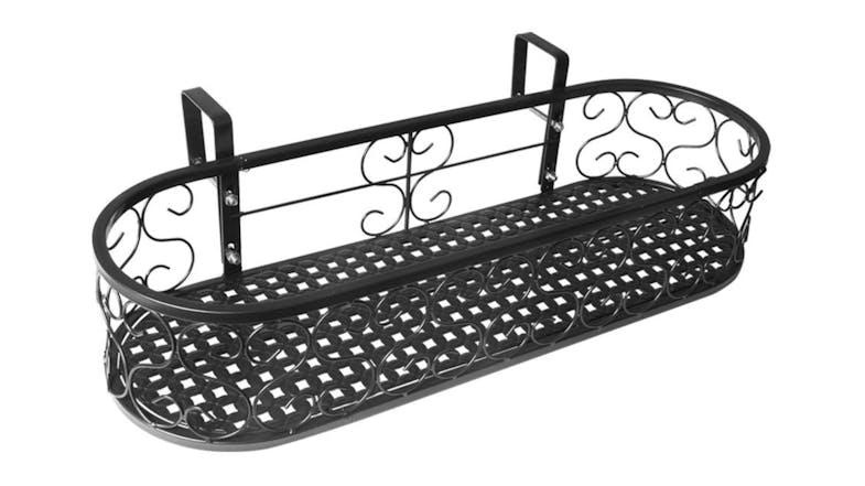 Black oval metal hanging plant holder with decorative scrollwork and hooks for mounting on a railing Black oval metal hanging plant holder with decorative scrollwork and hooks for mounting on a railing