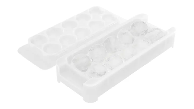 A close‑up of a white plastic ice tray, partially filled with round ice cubes, showing its removable design A close‑up of a white plastic ice tray, partially filled with round ice cubes, showing its removable design