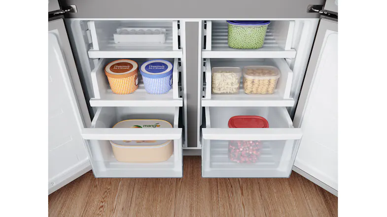 An open view of the freezer compartments containing ice cream tubs, pasta, berries, and frozen foods An open view of the freezer compartments containing ice cream tubs, pasta, berries, and frozen foods