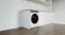 Wide view of a white front-load dryer installed in a modern kitchen Wide view of a white front-load dryer installed in a modern kitchen