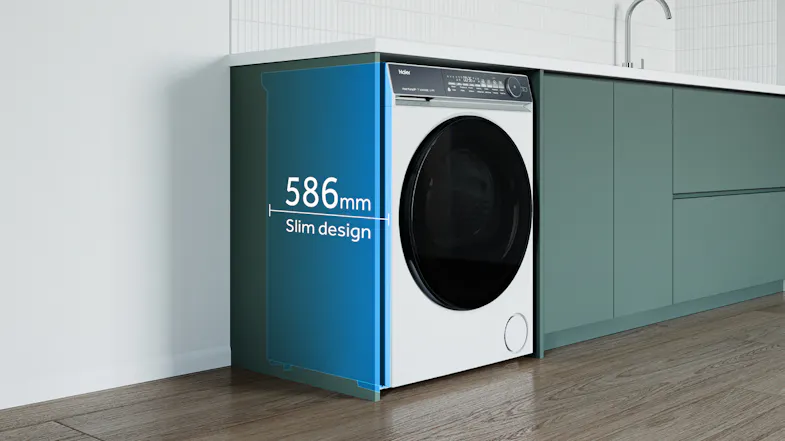 Angled view of a front-load dryer under a counter, highlighting a 586mm slim depth Angled view of a front-load dryer under a counter, highlighting a 586mm slim depth