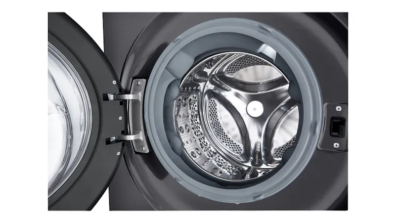 Interior view of the stainless steel washer drum with a front-open door Interior view of the stainless steel washer drum with a front-open door