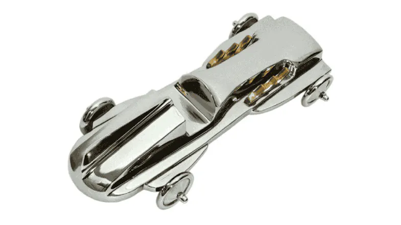 Silver nickel decorative car ornament with a sleek, elongated vintage‑style design, featuring small wheel details Silver nickel decorative car ornament with a sleek, elongated vintage‑style design, featuring small wheel details