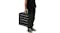 A person holding the folded black pet ramp by its handle like a compact suitcase A person holding the folded black pet ramp by its handle like a compact suitcase