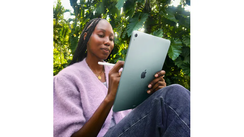 A woman writing notes using the sleek iPad Air (2026) in a lush garden setting A woman writing notes using the sleek iPad Air (2026) in a lush garden setting