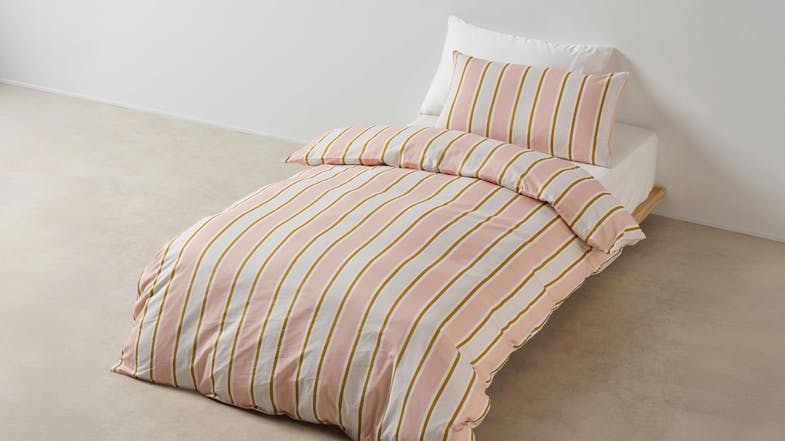 Sailor Stripe Pink Duvet Cover Set by Linen House Kids on a single bed in a bright room Sailor Stripe Pink Duvet Cover Set by Linen House Kids on a single bed in a bright room