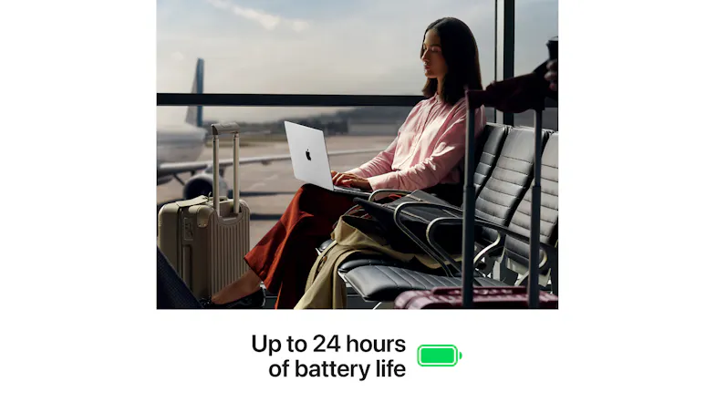 A person using a MacBook Pro at an airport with a "24-hour battery" text A person using a MacBook Pro at an airport with a "24-hour battery" text
