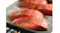 Close‑up of salmon fillets on a baking tray inside the oven, showing even steam‑assisted cooking Close‑up of salmon fillets on a baking tray inside the oven, showing even steam‑assisted cooking