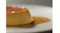 Close‑up of a custard dessert topped with caramel sauce on a white plate Close‑up of a custard dessert topped with caramel sauce on a white plate