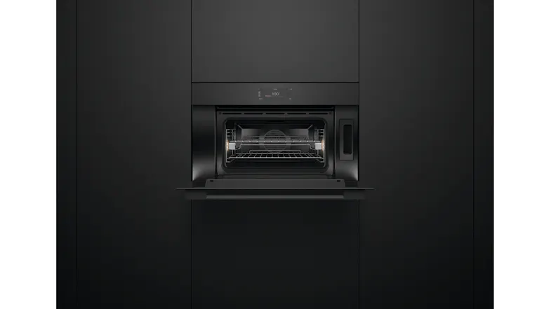 Oven installed in black cabinetry with the door open, revealing the illuminated interior and two shelves Oven installed in black cabinetry with the door open, revealing the illuminated interior and two shelves