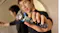 A person holding the shaver forward, showing the glowing digital display A person holding the shaver forward, showing the glowing digital display