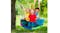 Group of kids riding a rainbow saucer swing outdoors in a green backyard setting Group of kids riding a rainbow saucer swing outdoors in a green backyard setting