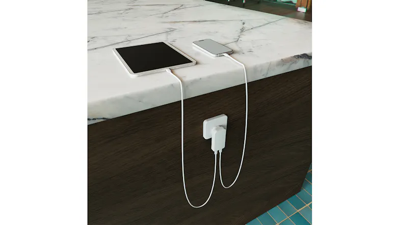 Cygnett charger plugged into a kitchen island, charging a tablet and phone on the counter Cygnett charger plugged into a kitchen island, charging a tablet and phone on the counter