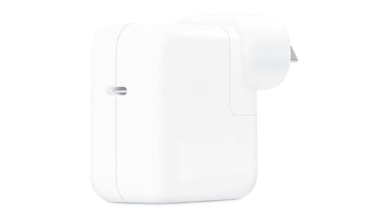 An Apple 30W USB-C Power Adapter in a sleek white colour An Apple 30W USB-C Power Adapter in a sleek white colour