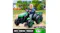 Green kids’ electric ride‑on tractor with trailer shown outdoors on a dirt path Green kids’ electric ride‑on tractor with trailer shown outdoors on a dirt path