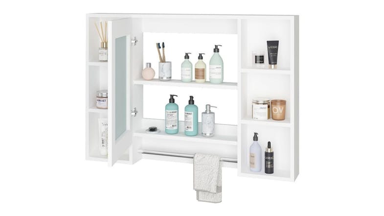 White bathroom wall cabinet with open shelves and a mirror door displaying toiletries, bottles, and a towel hanging on the lower bar White bathroom wall cabinet with open shelves and a mirror door displaying toiletries, bottles, and a towel hanging on the lower bar