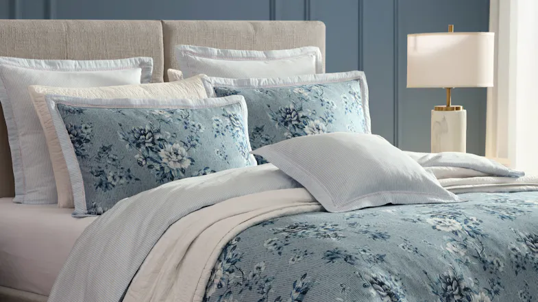 Close-up view of the Liyana Blue Duvet Cover Set, highlighting the pillowcases and floral fabric pattern Close-up view of the Liyana Blue Duvet Cover Set, highlighting the pillowcases and floral fabric pattern
