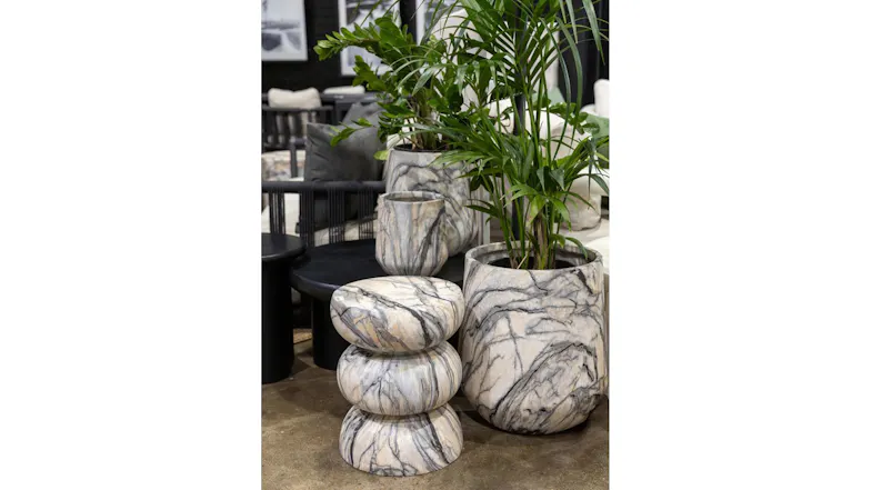 Styled Bower marble MGO planters with lush green plants next to a matching decorative stone stool Styled Bower marble MGO planters with lush green plants next to a matching decorative stone stool
