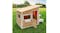 An outdoor playhouse with a slanted roof, an open door and a side bench set on green grass An outdoor playhouse with a slanted roof, an open door and a side bench set on green grass