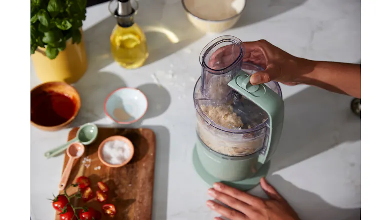 A view of a hand operating the food processor A view of a hand operating the food processor