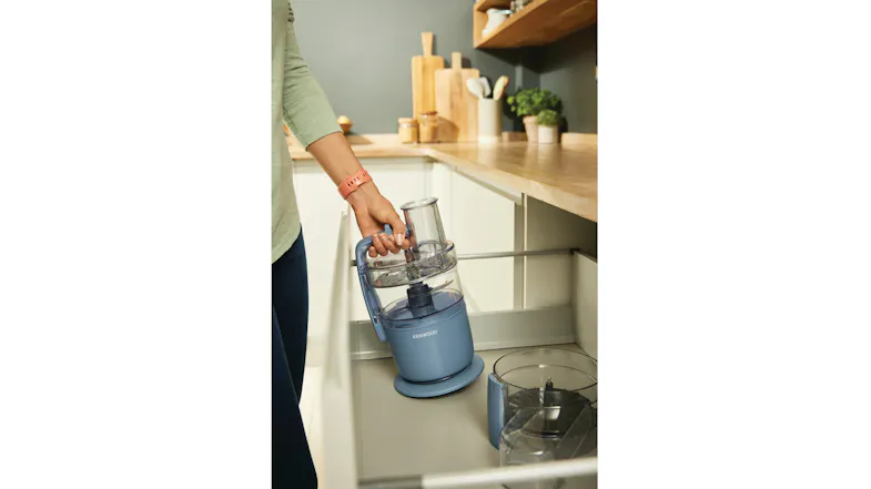 A person lifting the compact Kenwood MultiPro Go food processor out of a deep kitchen drawer A person lifting the compact Kenwood MultiPro Go food processor out of a deep kitchen drawer