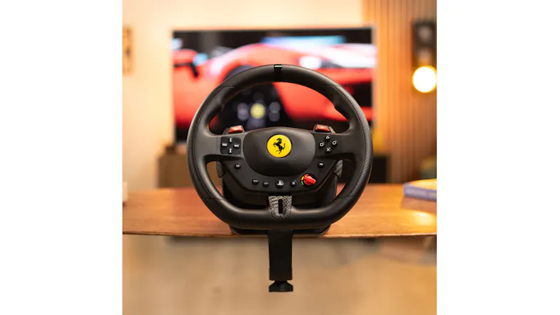 Black wheel on a wooden table with a Ferrari logo Black wheel on a wooden table with a Ferrari logo