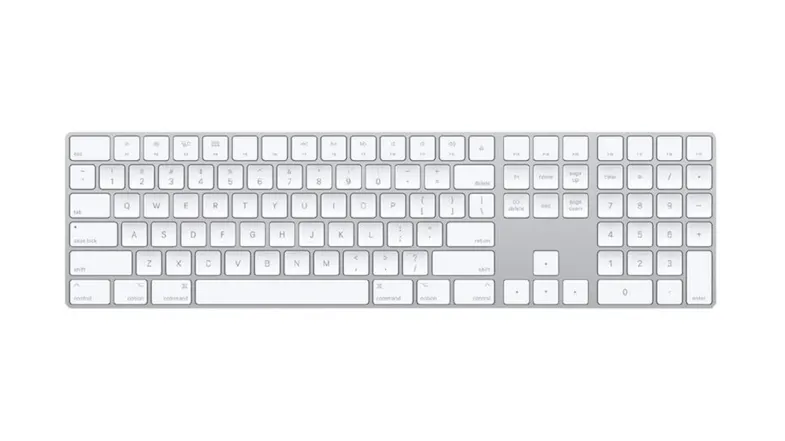 Top-down view of a silver Apple Magic Keyboard with Numeric Keypad and white keys Top-down view of a silver Apple Magic Keyboard with Numeric Keypad and white keys