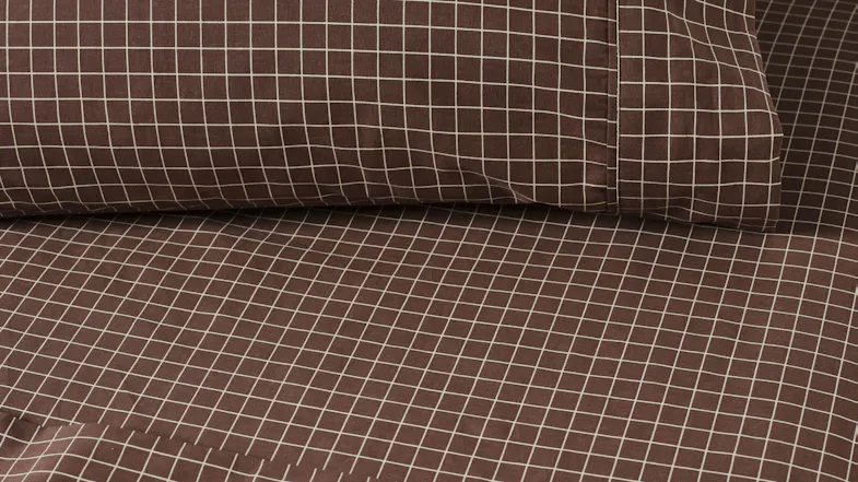 Close-up of the fitted sheet and pillowcase from the Volley Check Chocolate set Close-up of the fitted sheet and pillowcase from the Volley Check Chocolate set