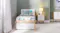 Front view of a wooden bed with a closed storage drawer Front view of a wooden bed with a closed storage drawer