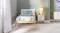Front view of a wooden bed frame next to a white nightstand Front view of a wooden bed frame next to a white nightstand