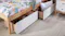 Two open white drawers with garments and a pillow Two open white drawers with garments and a pillow