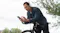 Person on a bicycle wearing JBL headphones outdoors Person on a bicycle wearing JBL headphones outdoors