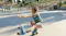 A person wearing JBL headphones while roller skating in a low squat A person wearing JBL headphones while roller skating in a low squat